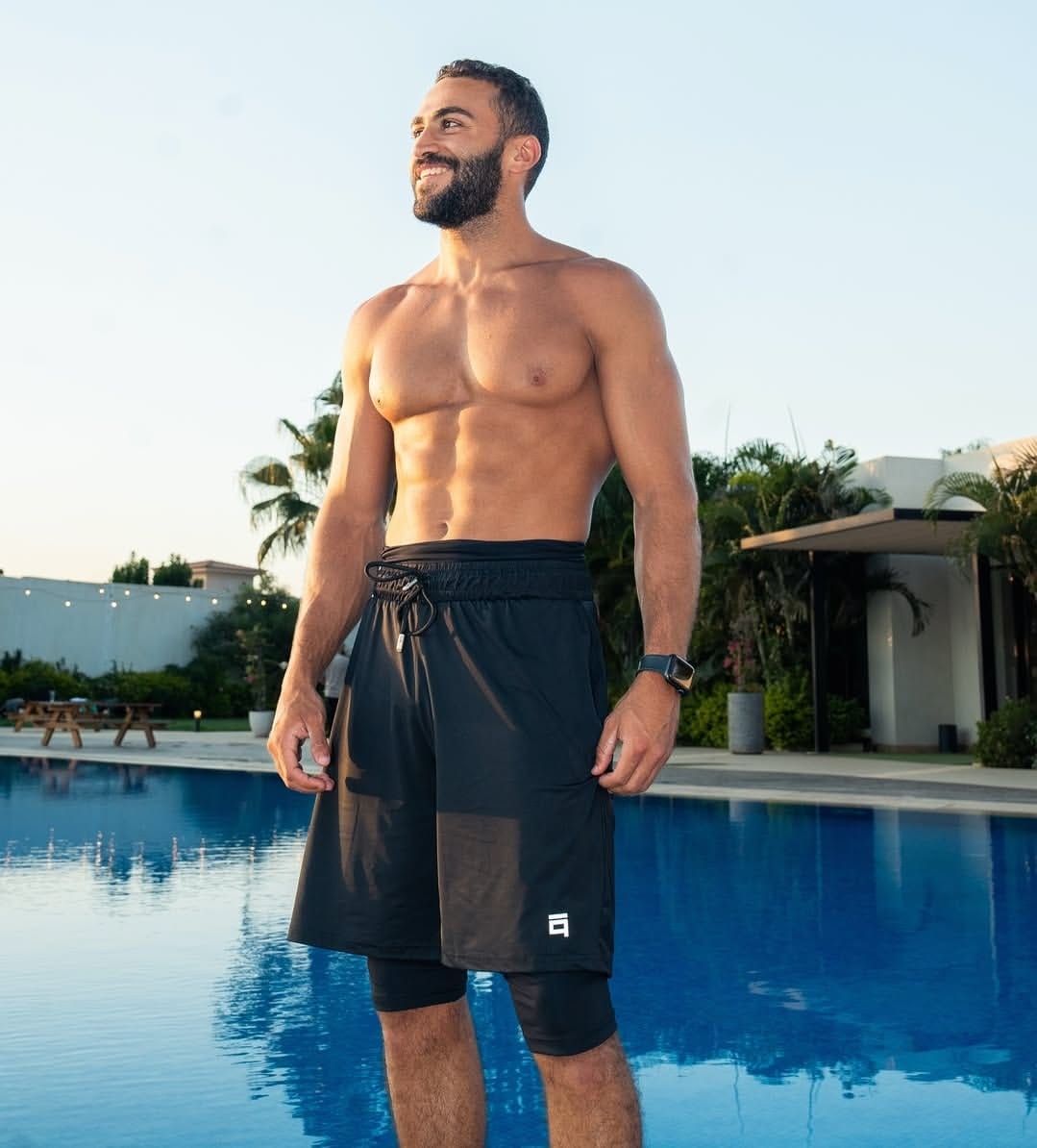 Stabraq All in One dark shorts worn poolside with the inner layer visible