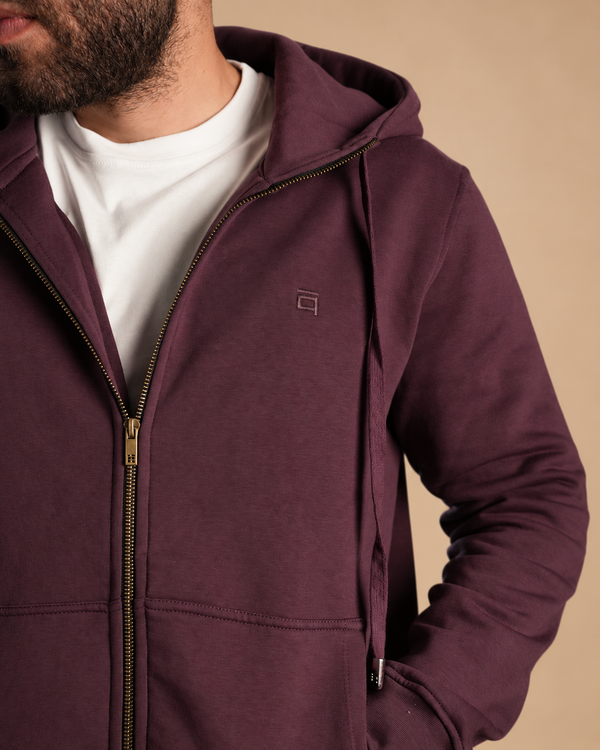 Stabraq High Neck Melton Zipper in burgundy, close-up of the hood, chest embroidery and zipper on a beige studio background