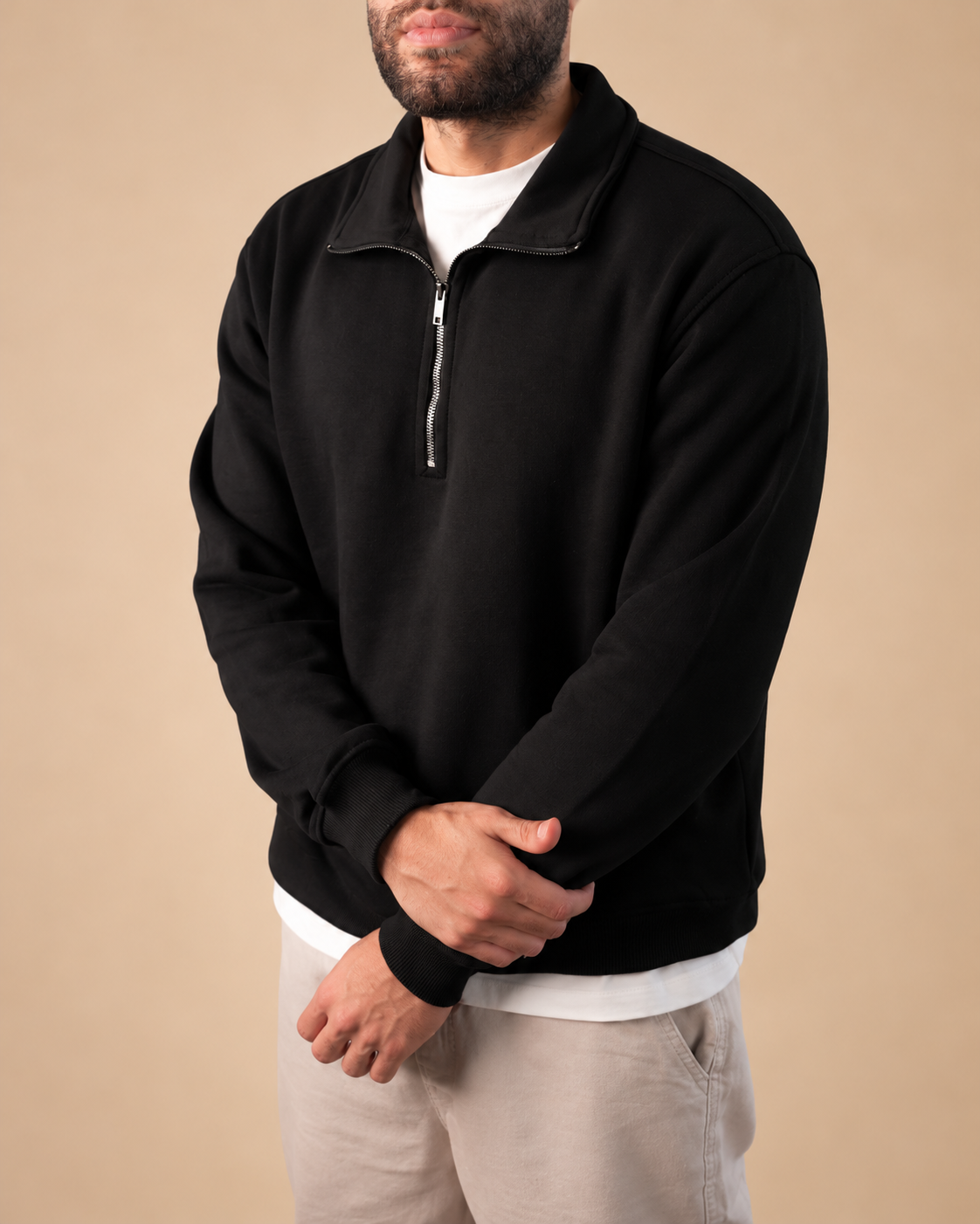 Stabraq Black Quarter Zipper, upper-body view cropped to the lower face on a beige studio background