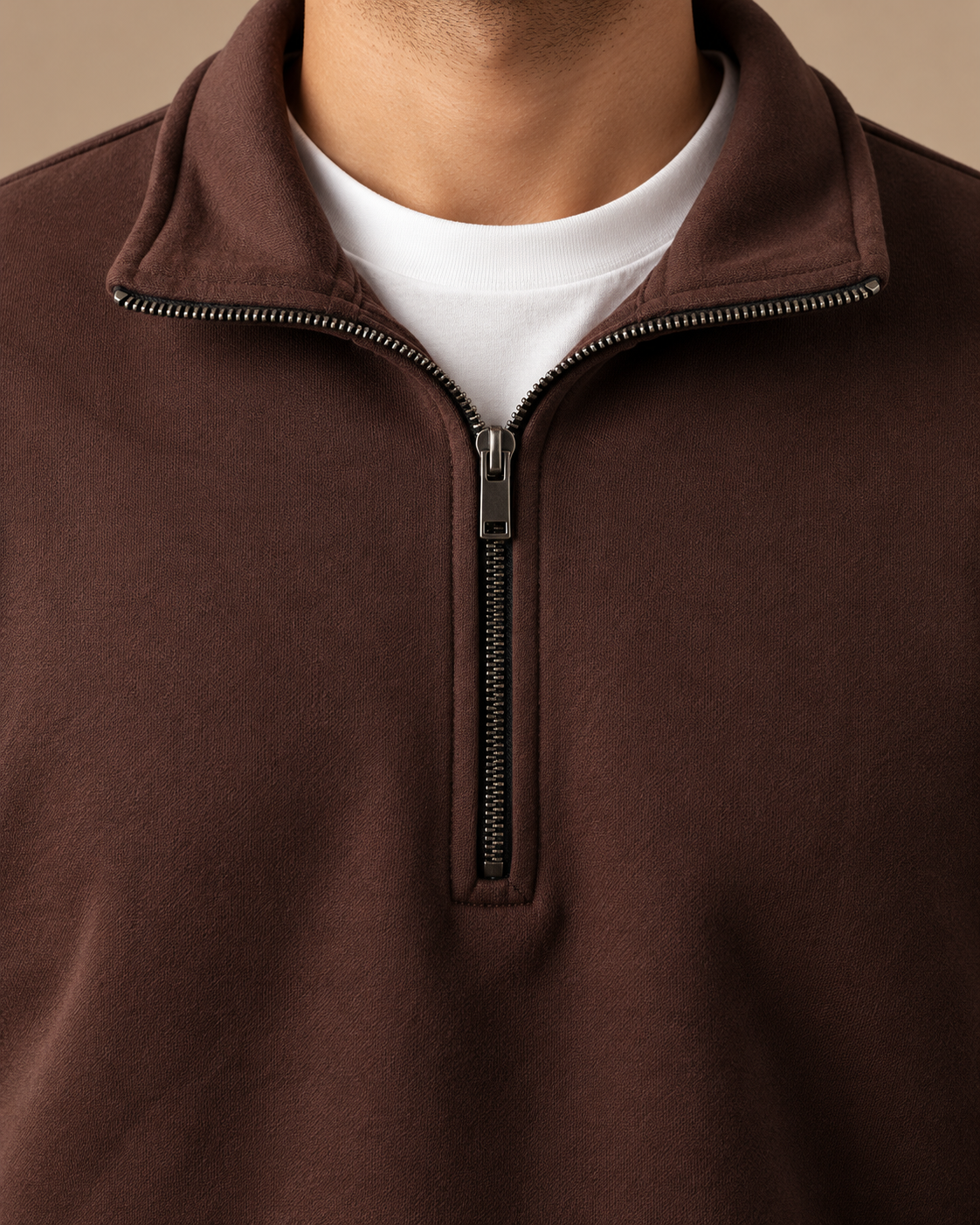 Stabraq Brown Quarter Zipper, tight close-up of collar, zipper and fabric on a beige studio background