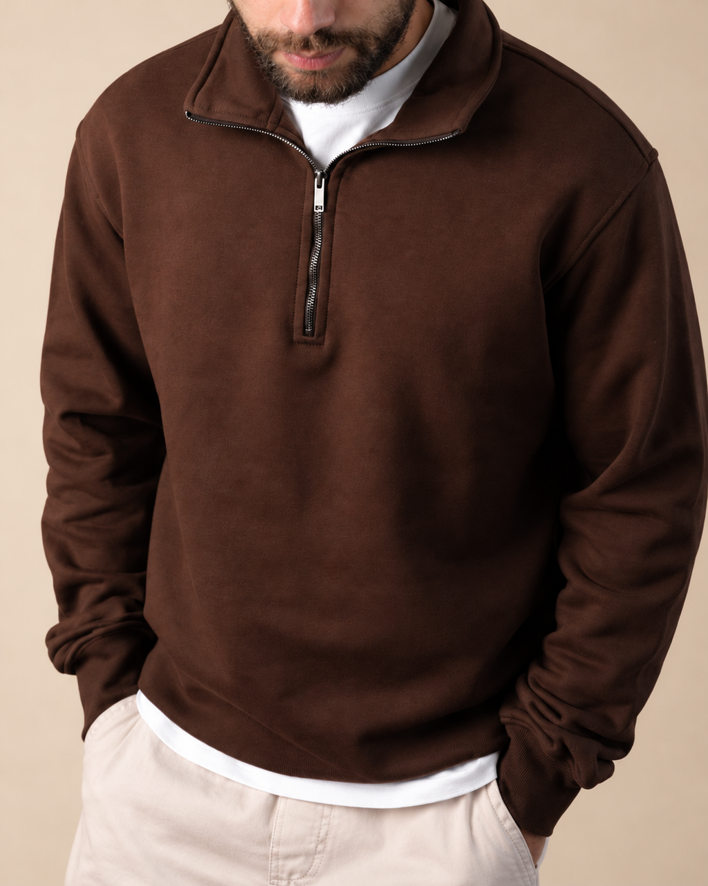 Stabraq Brown Quarter Zipper, upper-body view cropped to the lower face on a beige studio background