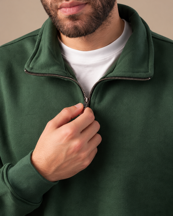 Stabraq Green Quarter Zipper, tight close-up of collar, zipper and fabric on a beige studio background