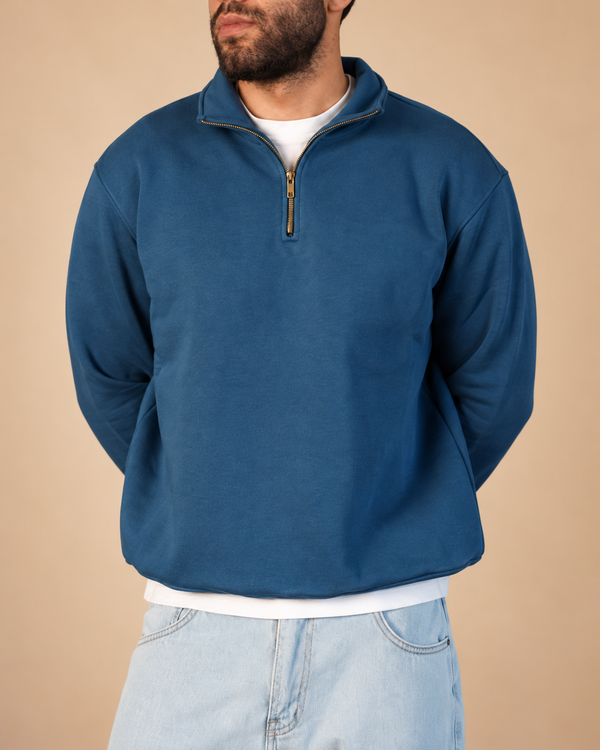 Stabraq Indigo Quarter Zipper, upper-body view cropped to the lower face on a beige studio background