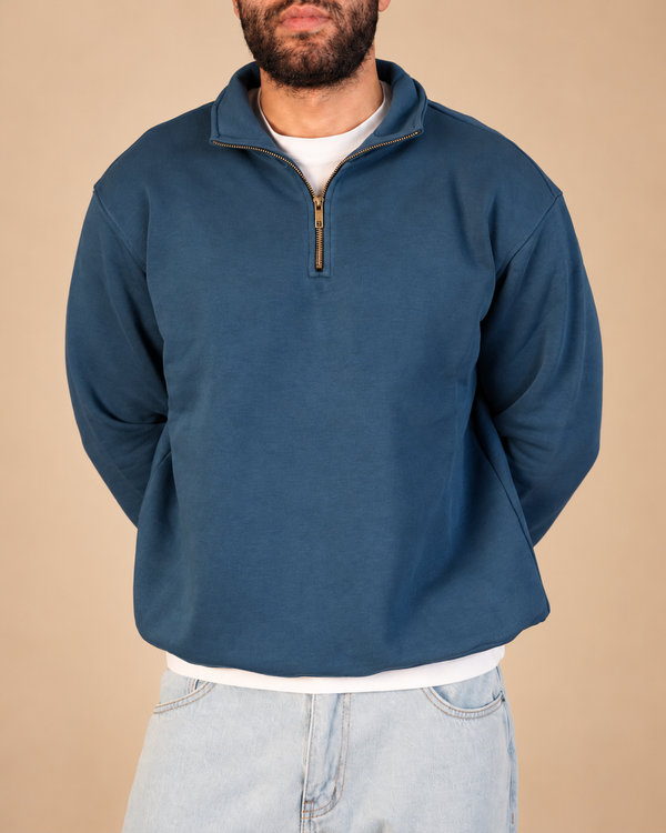 Stabraq Indigo Quarter Zipper, upper-body view cropped to the lower face on a beige studio background
