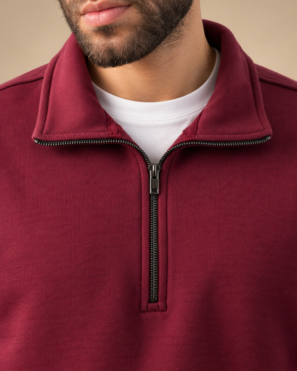 Stabraq Maroon Quarter Zipper, tight close-up of collar, zipper and fabric on a beige studio background