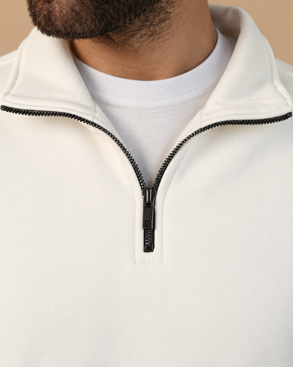 Stabraq Off White Quarter Zipper, tight close-up of collar, zipper and fabric on a beige studio background
