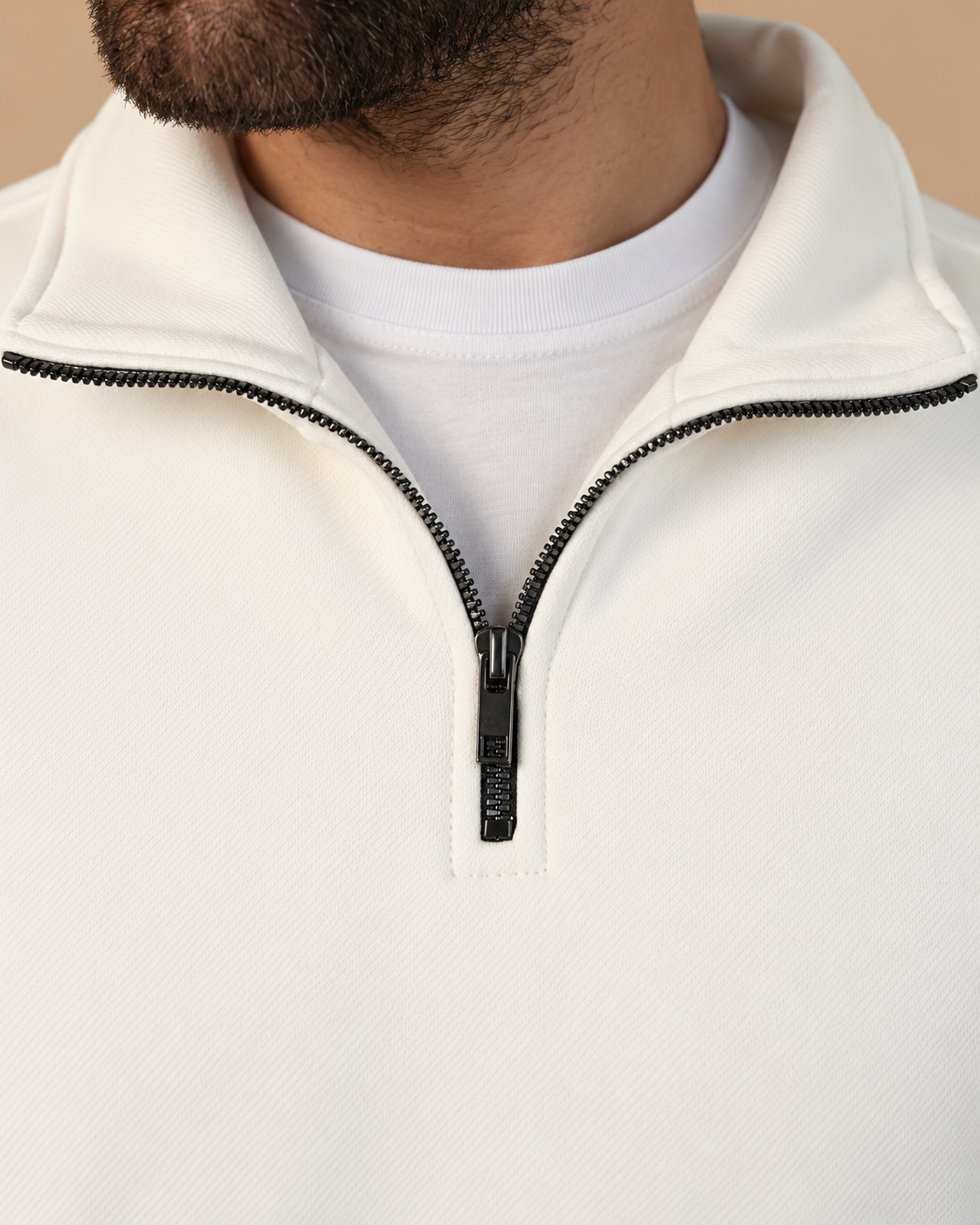 Stabraq Off White Quarter Zipper, tight close-up of collar, zipper and fabric on a beige studio background