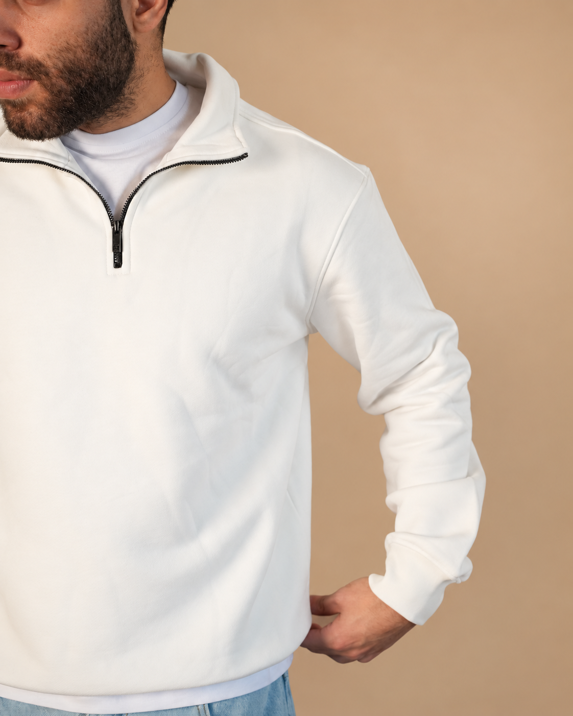 Stabraq Off White Quarter Zipper, close-up of the collar, zipper and fabric on a beige studio background