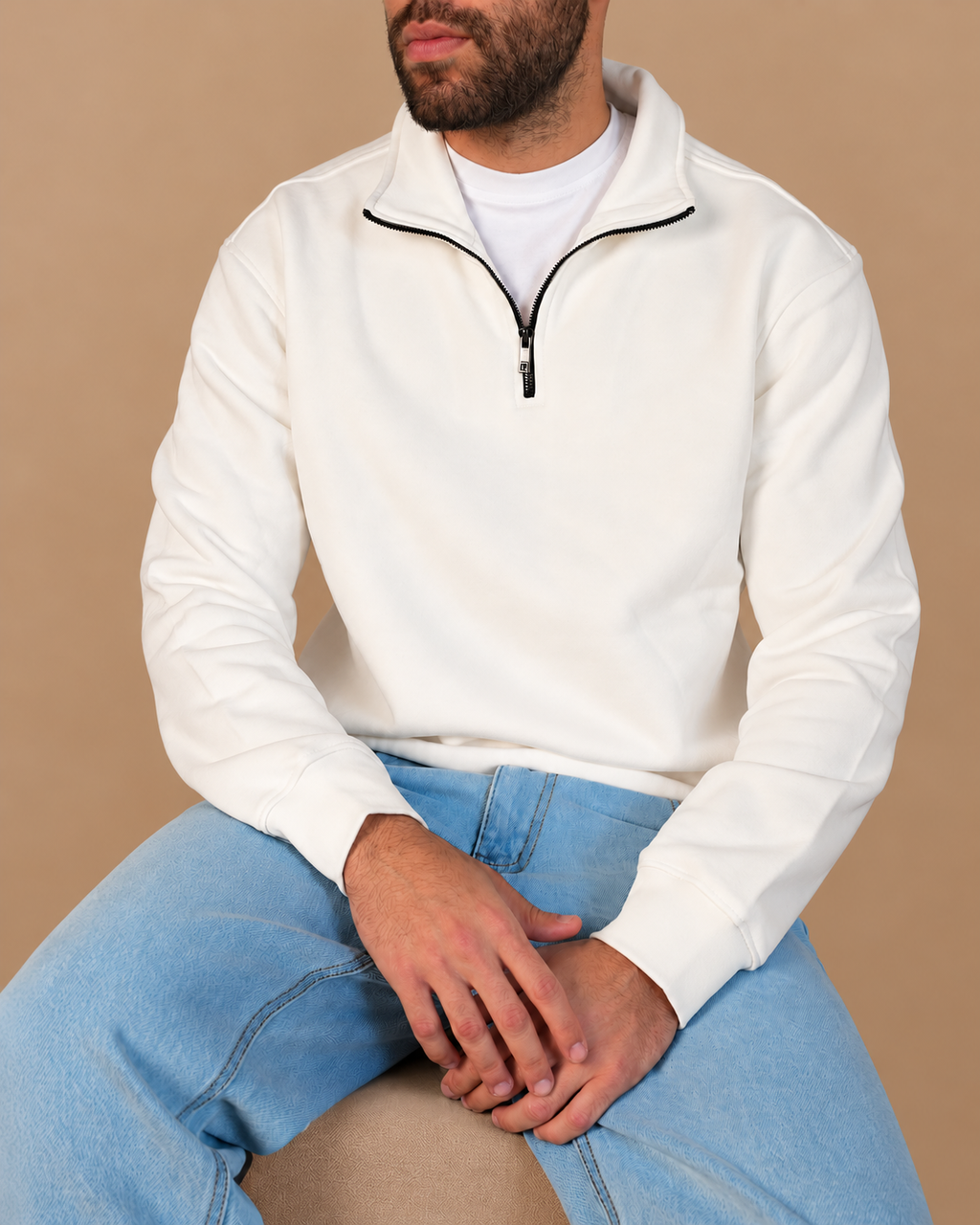 Stabraq Off White Quarter Zipper, seated upper-body view with lower-face crop on a beige studio background