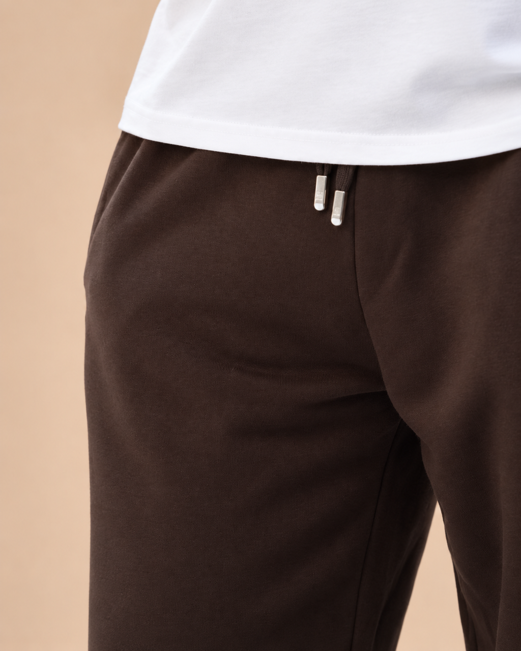 Wide-Leg Sweatpants Brown - close-up waist and drawstring detail in beige studio