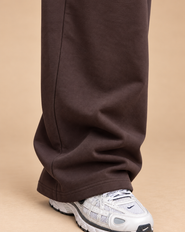 Wide-Leg Sweatpants Brown - close-up open hem and fabric detail in beige studio